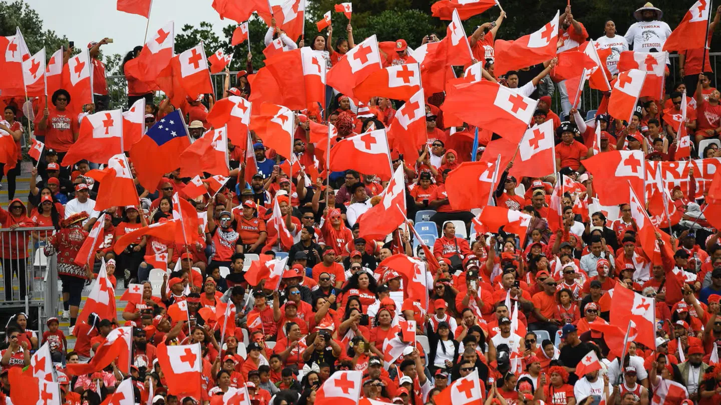 Tongan community supporters waving flags in Auckland, New Zealand