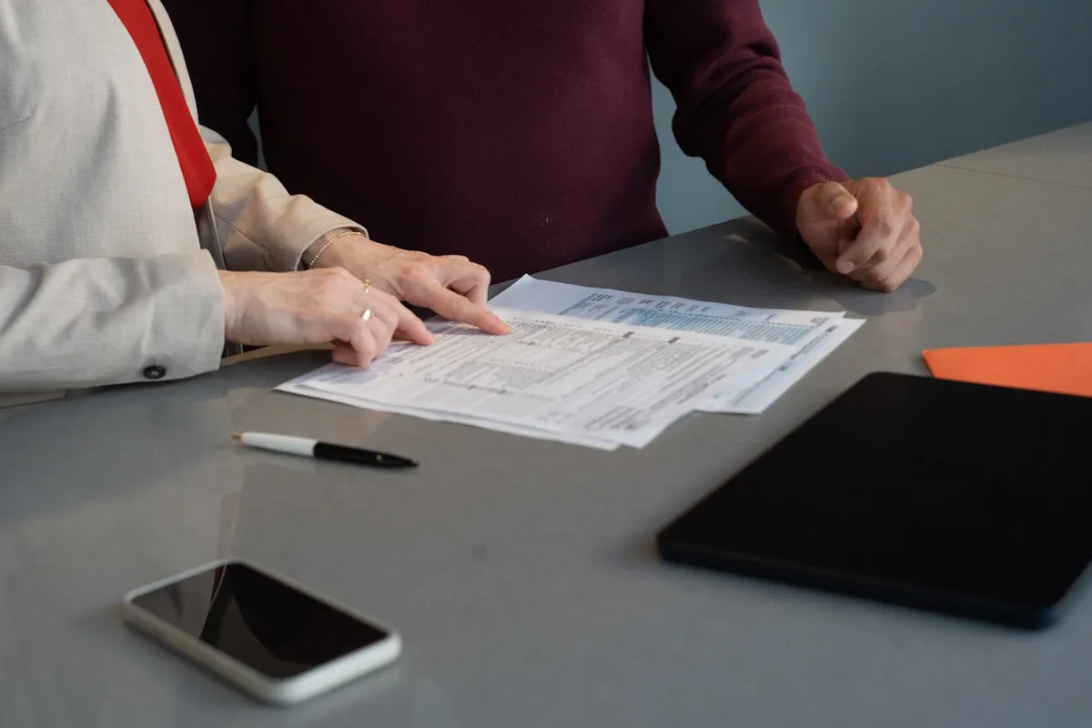 Two people reviewing a document together at a desk